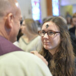 a woman with ash cross on her forehead